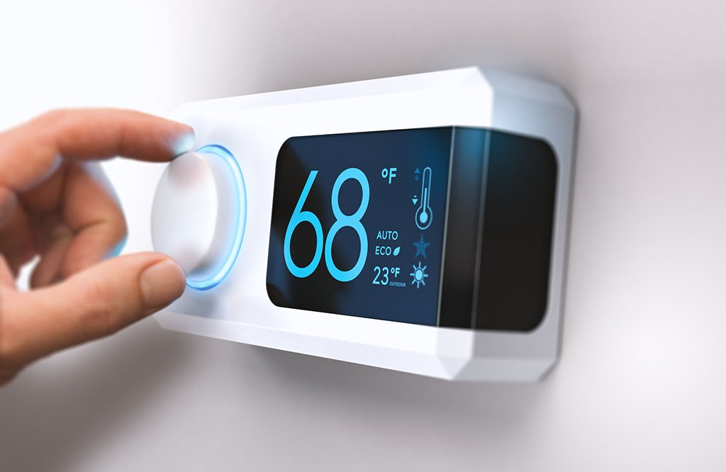 A hand adjusts a Programmable Thermostat displaying a temperature of 68°F, with additional settings and icons on the screen—showcasing the energy savings and benefits of smart climate control.