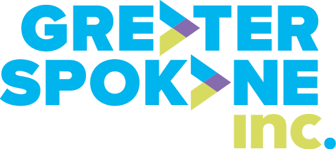 Logo for Greater Spokane Inc. with the words "GREATER SPOKANE inc." in blue and green, featuring arrow-shaped designs within some letters, representing the spirit of Spokane and its ties to the Greater Spokane Chamber Of Commerce.