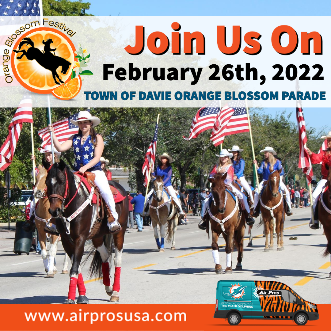 People in patriotic attire ride horses and carry American flags in a parade, celebrating the 2022 Davie Orange Blossom Parade on February 26th, with sponsorship from Air Pros.